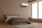 A Seiya air conditioner in a cozy brown bedroom